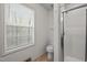 A clean bathroom with a window, toilet, and stand up shower at 922 Royal Oaks Dr, Durham, NC 27712