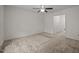 Neutral bedroom with ceiling fan, carpet and access to hall at 922 Royal Oaks Dr, Durham, NC 27712