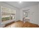 Bright dining area with hardwood floors and view of the front yard through large windows at 922 Royal Oaks Dr, Durham, NC 27712