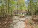 Secluded single-story home nestled in a wooded area with mature trees providing shade and privacy at 922 Royal Oaks Dr, Durham, NC 27712