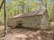 Beige home featuring a walkout basement, back deck and surrounded by mature trees offering privacy at 922 Royal Oaks Dr, Durham, NC 27712