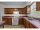 Well-lit kitchen features plenty of counter space, a stove, and stainless steel sink beneath a window at 922 Royal Oaks Dr, Durham, NC 27712