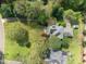 An aerial view of the property, including the house, landscaping, and surrounding neighborhood at 104 Glenview Pl, Chapel Hill, NC 27514