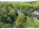 Aerial view of a home in a lush, tree-lined neighborhood with a long driveway at 104 Glenview Pl, Chapel Hill, NC 27514