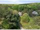 Stunning aerial view of a charming home nestled among lush green trees and manicured lawns at 104 Glenview Pl, Chapel Hill, NC 27514
