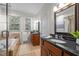 Bright bathroom featuring double vanities, a soaking tub, and a tiled shower with glass door at 104 Glenview Pl, Chapel Hill, NC 27514