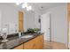 Bathroom features a dark granite countertop, wooden cabinetry, a large mirror, and modern light fixtures at 104 Glenview Pl, Chapel Hill, NC 27514