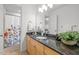 Bathroom showcasing granite countertop, wooden cabinets, stylish decor, and a shower with a floral curtain at 104 Glenview Pl, Chapel Hill, NC 27514