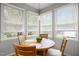 Eat-in kitchen features a round wooden table near a window with views of the outdoors at 104 Glenview Pl, Chapel Hill, NC 27514