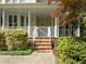 The front entrance features a brick staircase leading up to a covered porch with white railings and columns at 104 Glenview Pl, Chapel Hill, NC 27514