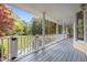 Spacious covered front porch with white railings and columns, offering a relaxing outdoor space with a yard view at 104 Glenview Pl, Chapel Hill, NC 27514