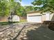 View of the garage and backyard featuring a basketball court at 104 Glenview Pl, Chapel Hill, NC 27514