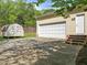 View of the garage featuring a large driveway and a shed in the backyard at 104 Glenview Pl, Chapel Hill, NC 27514