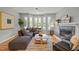 Bright and airy living room with large windows, hardwood floors, and a fireplace at 104 Glenview Pl, Chapel Hill, NC 27514