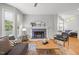 Cozy living room with a fireplace, hardwood floors, and comfortable seating at 104 Glenview Pl, Chapel Hill, NC 27514