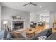 Open-concept living room featuring a fireplace and seamless access to the kitchen at 104 Glenview Pl, Chapel Hill, NC 27514