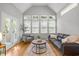 Cozy living room with vaulted ceilings, large windows, and neutral decor at 104 Glenview Pl, Chapel Hill, NC 27514
