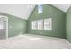 Spacious main bedroom with vaulted ceilings, three windows, and neutral carpeting providing ample natural light at 104 Glenview Pl, Chapel Hill, NC 27514