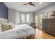 Bright main bedroom featuring a ceiling fan, french doors to the exterior, and wood flooring at 104 Glenview Pl, Chapel Hill, NC 27514