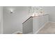 Staircase with wood handrail and carpeted stairs leading to a windowed landing at 104 Glenview Pl, Chapel Hill, NC 27514