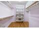 Walk-in closet with custom storage solutions, shelving, and wood floors at 104 Glenview Pl, Chapel Hill, NC 27514