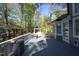 Spacious gray back deck features a sitting area and leads to the backyard at 105 Guldahl Ct, Morrisville, NC 27560