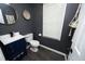 Cozy half bathroom featuring modern fixtures, stylish gray walls, and decorative elements at 105 Guldahl Ct, Morrisville, NC 27560