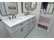 Bathroom with double vanity sinks, stylish fixtures, and a door that leads to the main bedroom at 105 Guldahl Ct, Morrisville, NC 27560