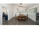 Elegant dining room with a wooden table, matching chairs, a white bookshelf, and views into the kitchen at 105 Guldahl Ct, Morrisville, NC 27560
