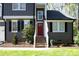 A close-up of the front door with a small garden, stairs, and an American flag, offering a warm welcome at 105 Guldahl Ct, Morrisville, NC 27560