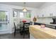 Bright kitchen with a breakfast nook area featuring a round table with chairs near the window and white cabinets at 105 Guldahl Ct, Morrisville, NC 27560