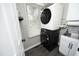 Modern laundry room featuring a stacked washer and dryer, stylish gray walls, and ample natural light at 105 Guldahl Ct, Morrisville, NC 27560