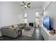 Spacious living room featuring high ceilings, a fireplace, a sectional sofa, and natural light from ample windows at 105 Guldahl Ct, Morrisville, NC 27560