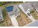 This aerial view shows a home with solar panels and a long driveway in a suburban neighborhood at 108 Pronghorn Deer Ct, Garner, NC 27529