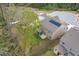 An aerial view of the home and yard shows mature trees and solar panels on the roof at 108 Pronghorn Deer Ct, Garner, NC 27529