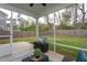 The screened back porch features outdoor furniture and a view of the grassy backyard with a wooden fence at 108 Pronghorn Deer Ct, Garner, NC 27529