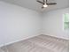 This bedroom features neutral carpeting and a ceiling fan at 108 Pronghorn Deer Ct, Garner, NC 27529