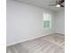 This bedroom has neutral carpet and paint, a ceiling fan, and a window letting in plenty of light at 108 Pronghorn Deer Ct, Garner, NC 27529