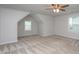 Bright, open bedroom with two windows, carpet, and a ceiling fan, providing a versatile and comfortable space at 108 Pronghorn Deer Ct, Garner, NC 27529