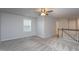 Spacious bonus room with plush carpeting, a ceiling fan, and natural light creating a versatile living space at 108 Pronghorn Deer Ct, Garner, NC 27529