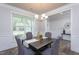 Formal dining room featuring modern decor, a chandelier, gray chairs, and plenty of natural light at 108 Pronghorn Deer Ct, Garner, NC 27529