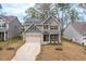 A front exterior of a two-story house with solar panels and a long driveway at 108 Pronghorn Deer Ct, Garner, NC 27529