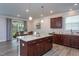 Bright open kitchen with granite island, recessed lighting, and access to the patio dining area at 108 Pronghorn Deer Ct, Garner, NC 27529