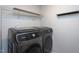 Laundry room with stainless steel Samsung washer and dryer set with shelf and rod for hanging clothes at 108 Pronghorn Deer Ct, Garner, NC 27529