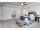 Serene main bedroom features a plush bed, tray ceiling, ceiling fan, and seating area complemented by soft, natural light at 108 Pronghorn Deer Ct, Garner, NC 27529