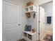Functional mudroom with built-in bench, storage shelves, and easy access to the bathroom at 108 Pronghorn Deer Ct, Garner, NC 27529