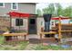 Backyard deck features an outdoor cooking area, chairs, and a red umbrella at 1105 Terrace Ct, Raleigh, NC 27615