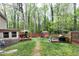 Expansive backyard with multiple entertaining areas, decks, and lush landscaping at 1105 Terrace Ct, Raleigh, NC 27615