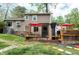 A backyard deck features an outdoor cooking area and a cozy seating space under a red umbrella at 1105 Terrace Ct, Raleigh, NC 27615