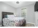 Comfortable bedroom featuring wood-look flooring, a large bed, and a window for natural light at 1105 Terrace Ct, Raleigh, NC 27615